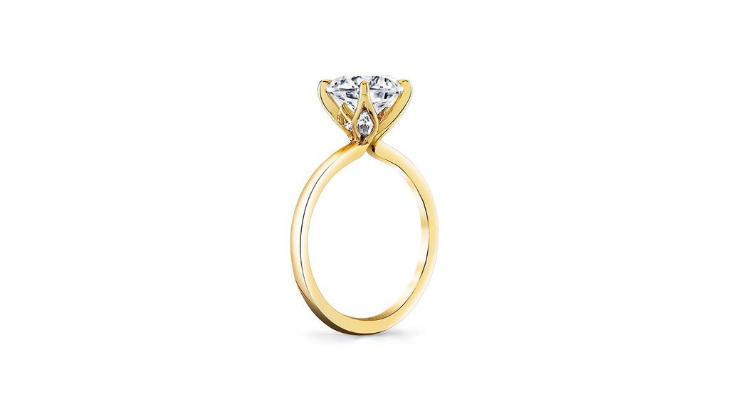 The “Chrys” engagement ring in yellow gold with the brand’s “Legacy Shell” profile and two white marquise-shaped diamonds set in the petals ($2,620 for the 14-karat gold semi-mount or $2,930 for 18-karat gold, center stone not included). Chrys engagement ring